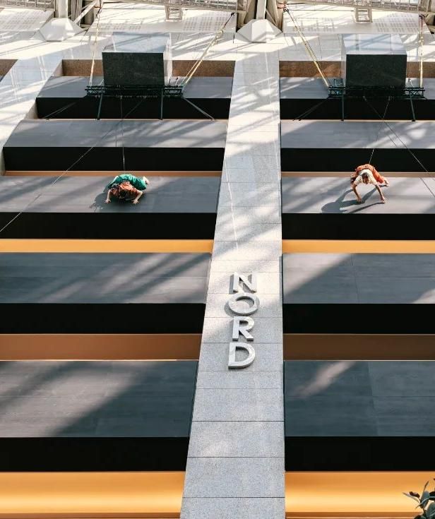 Danseurs aériens suspendus dans l'atrium, vus d'en haut